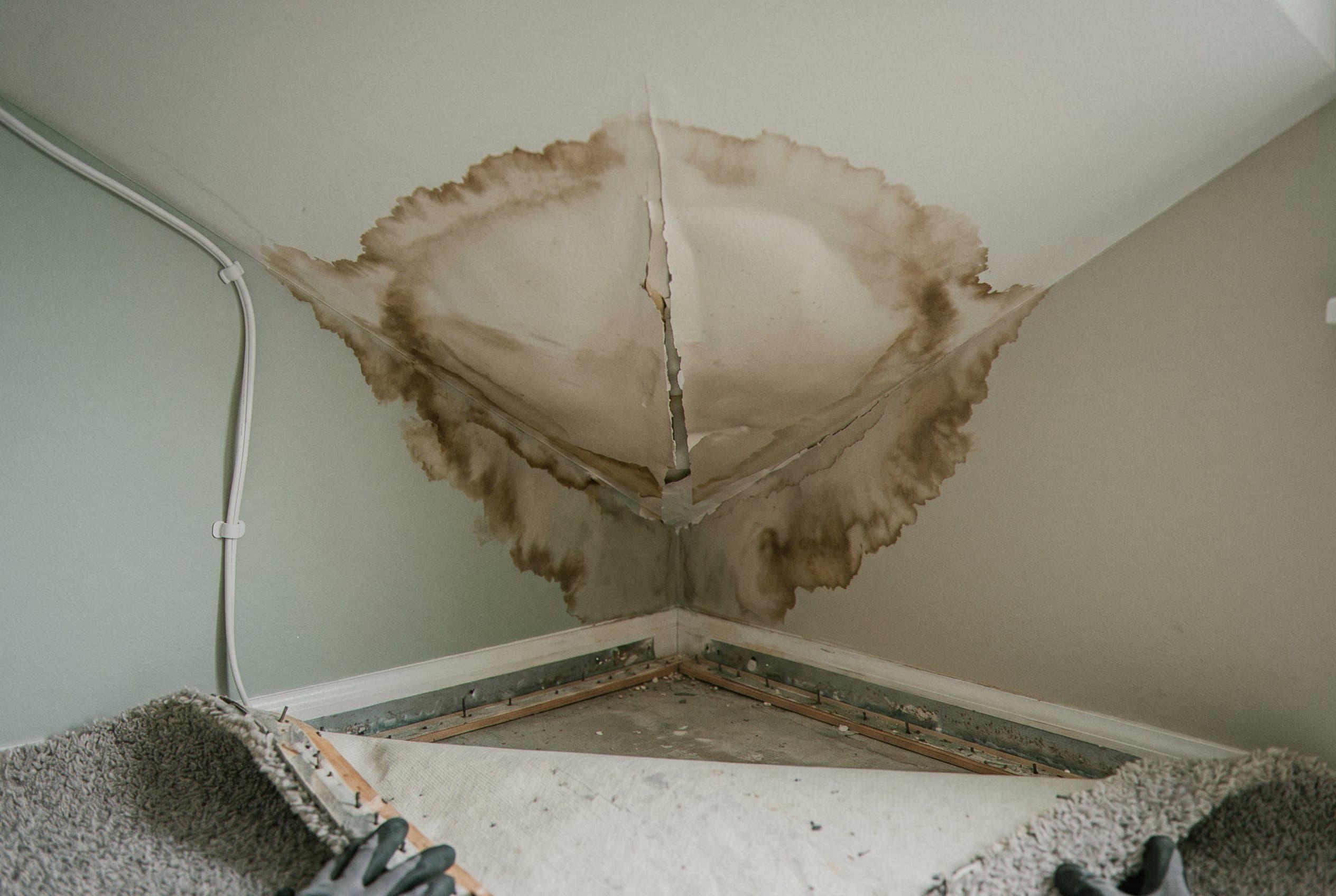 Water-damaged ceiling drywall sagging from moisture