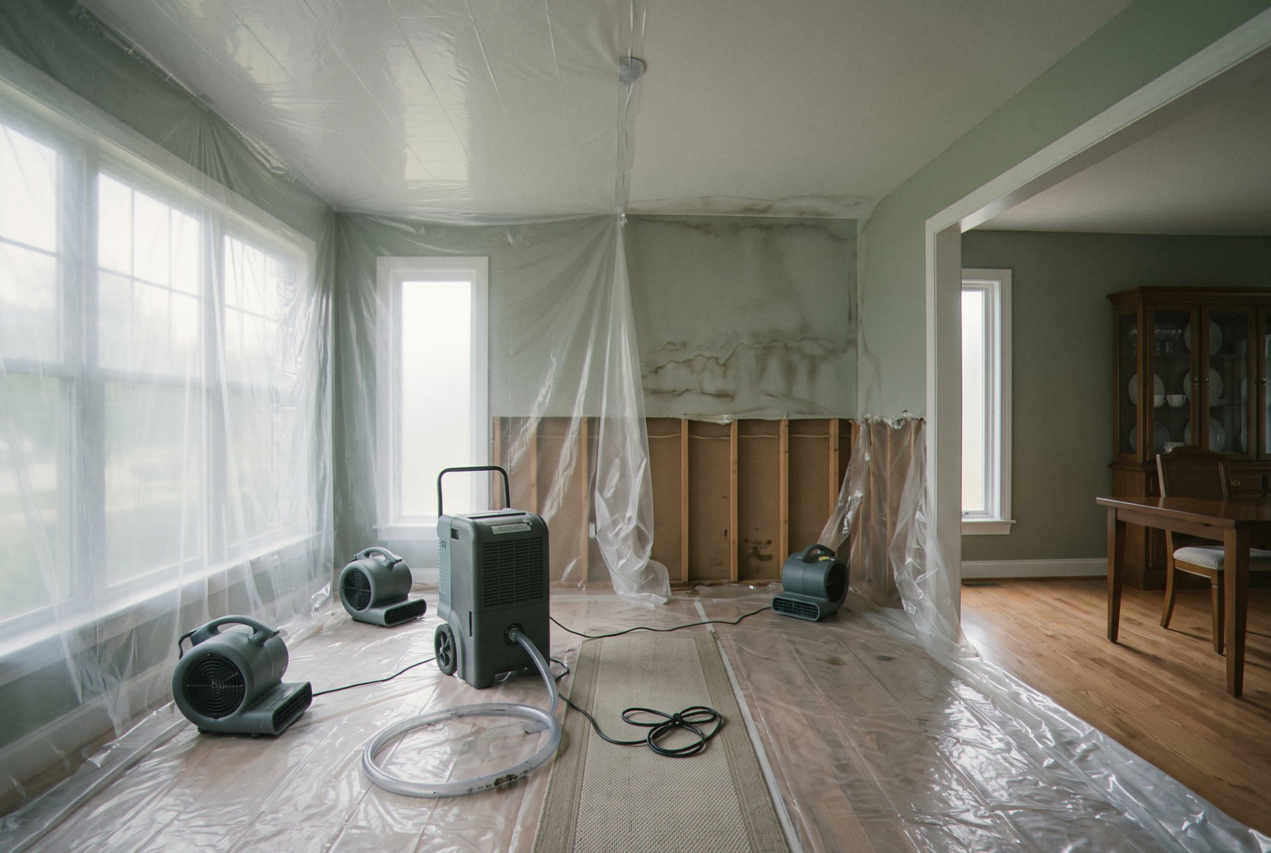 Commercial air movers drying wet drywall